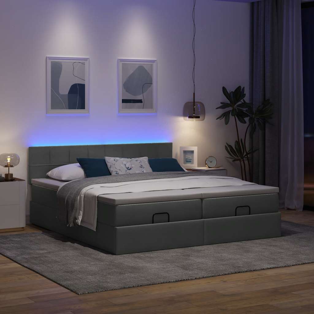Otomanski posteljni okvir z vzmetnicami siv 180×200 cm blago