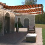 Ročno zložljiva tenda z LED lučmi 600x350 cm oranžna in rjava