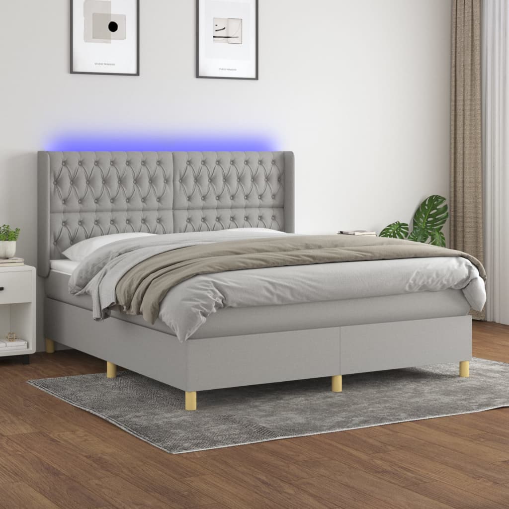 Box spring postelja z vzmetnico LED sv. siva 180×200 cm blago
