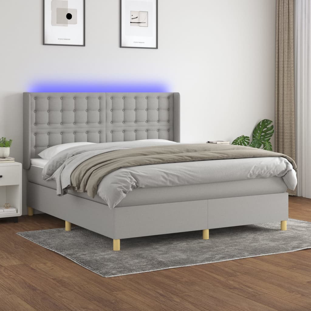 Box spring postelja z vzmetnico LED sv. siva 180×200 cm blago